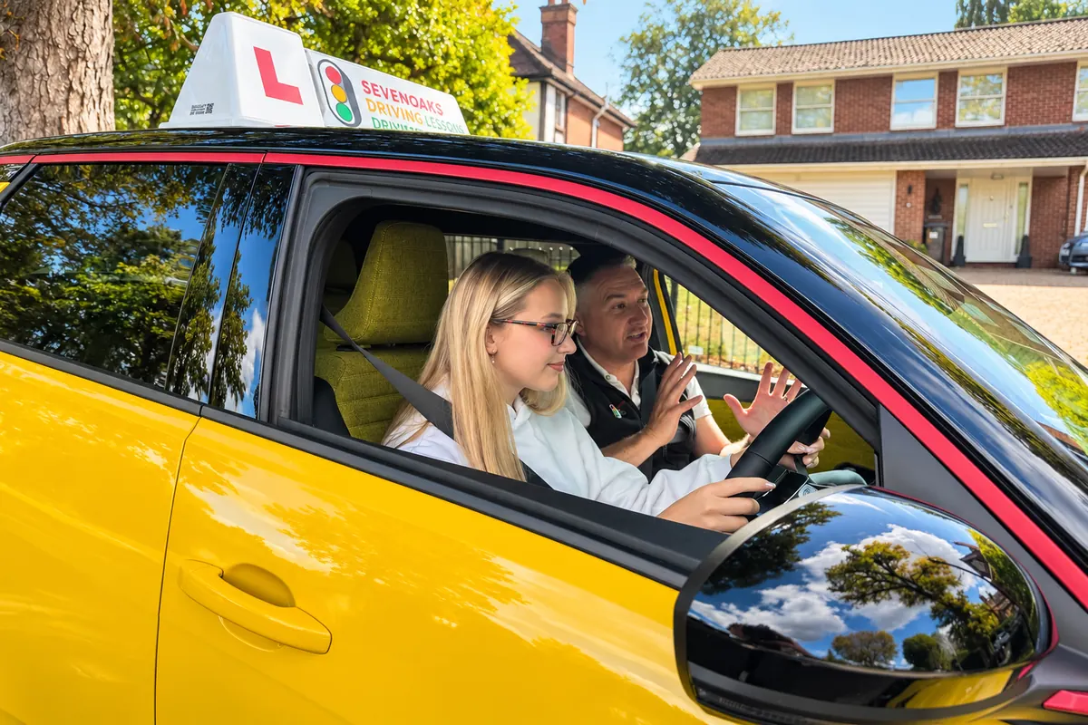 Geoff teaching a learner driver in Rene, his electric Renault 5